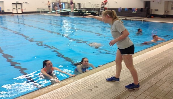 Lauren (20) coaching swimmers in a pool
