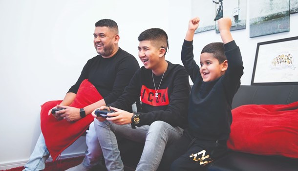 Zain playing video games with his family