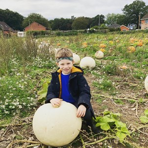 Boy with white pumpkin